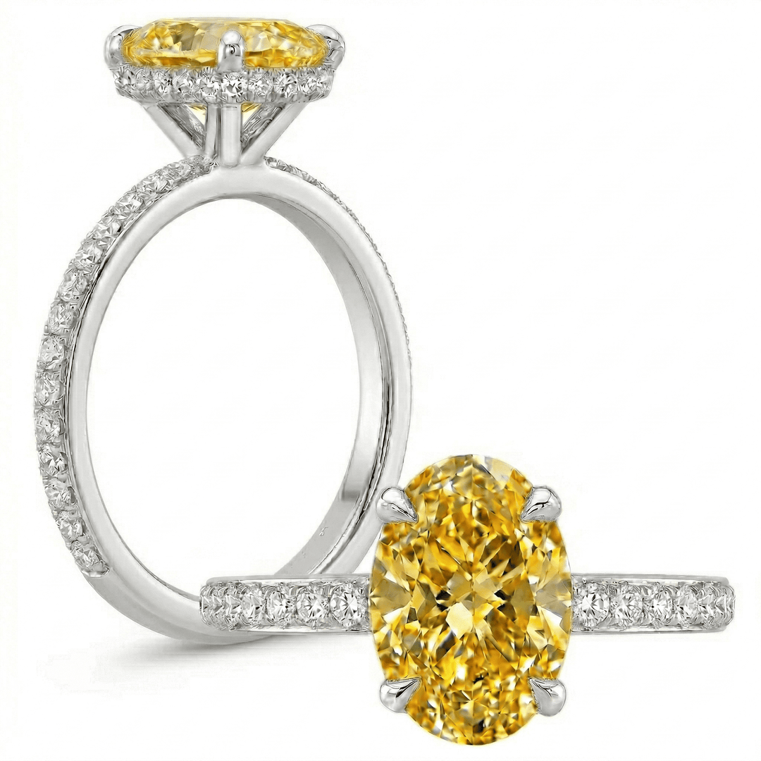 yellow oval ring with diamond accents on a white background