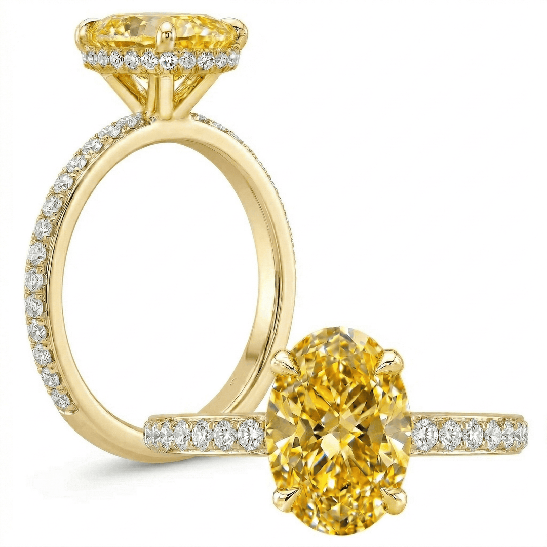 Gold ring with yellow gemstone and diamond accents on a white background
