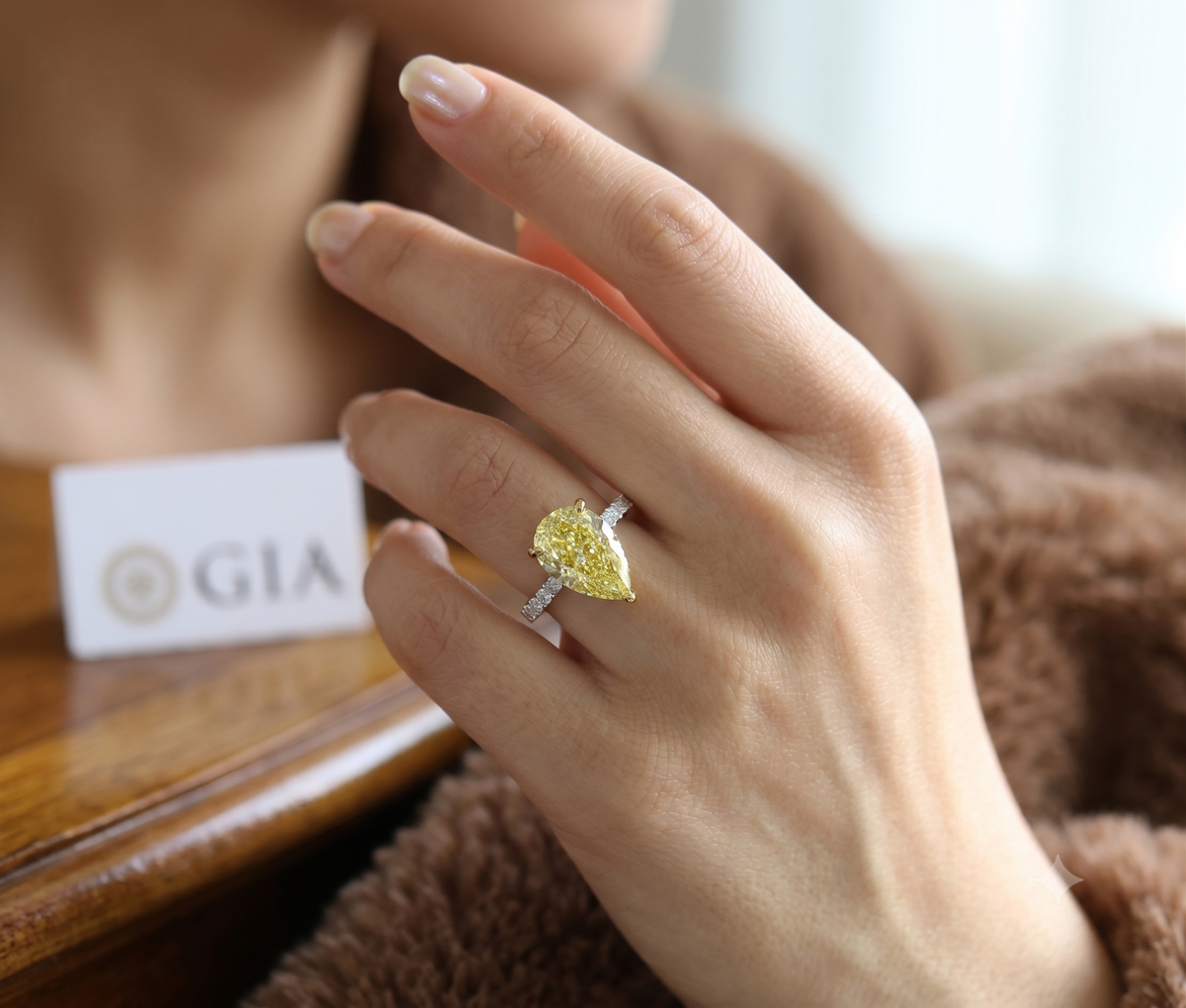 Yellow pear hidden halo ring on hand model