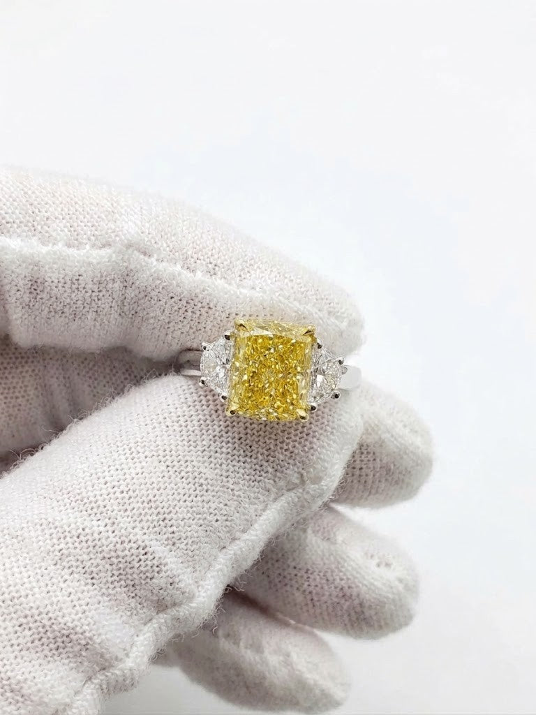 elongated yellow cushion with halfmoon 3-stone ring in white gold on hand