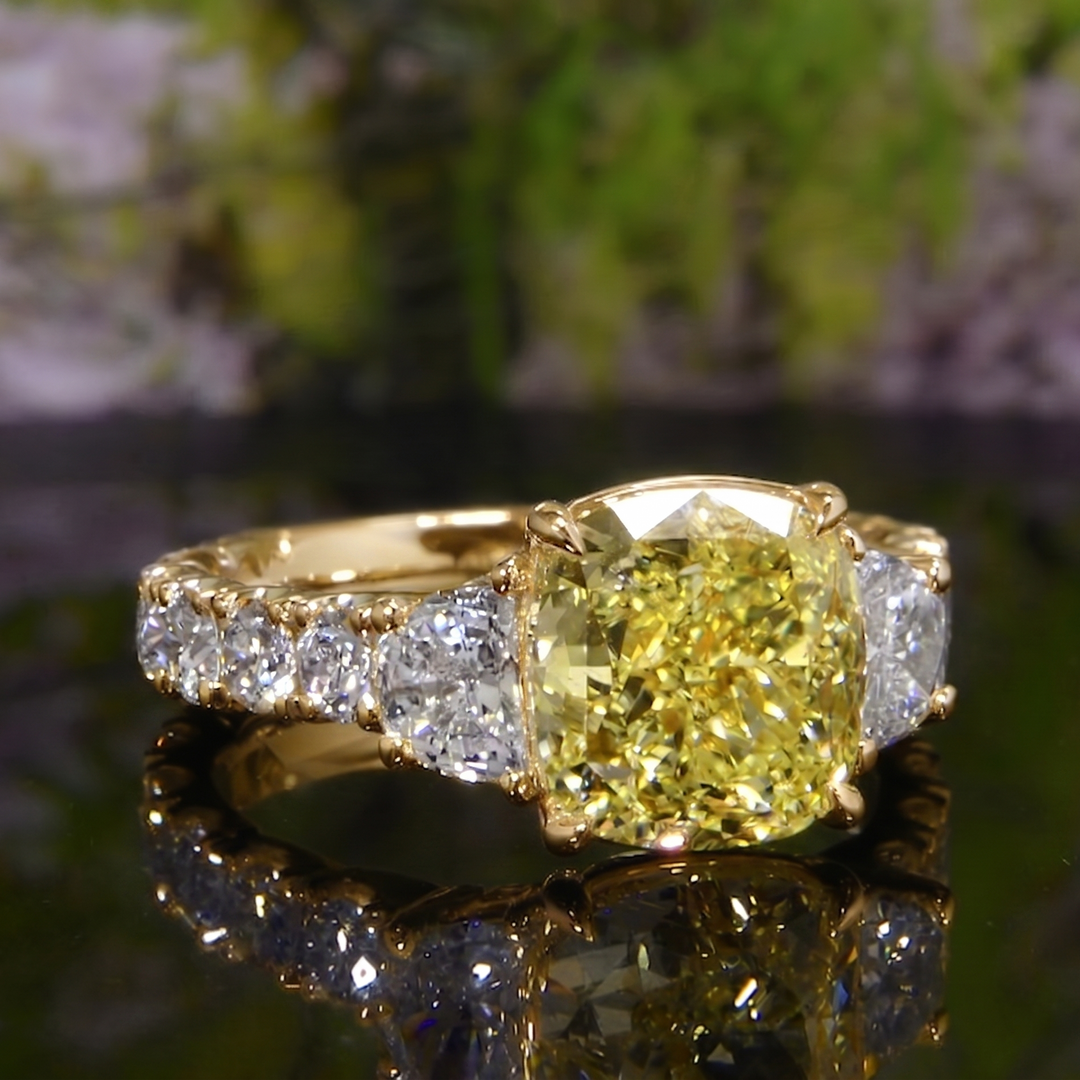 Yellow gold version of yellow cushion and half moon with big round cut stones on the shank diamond ring