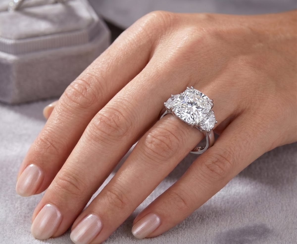 Diamond ring on a hand with a neutral background