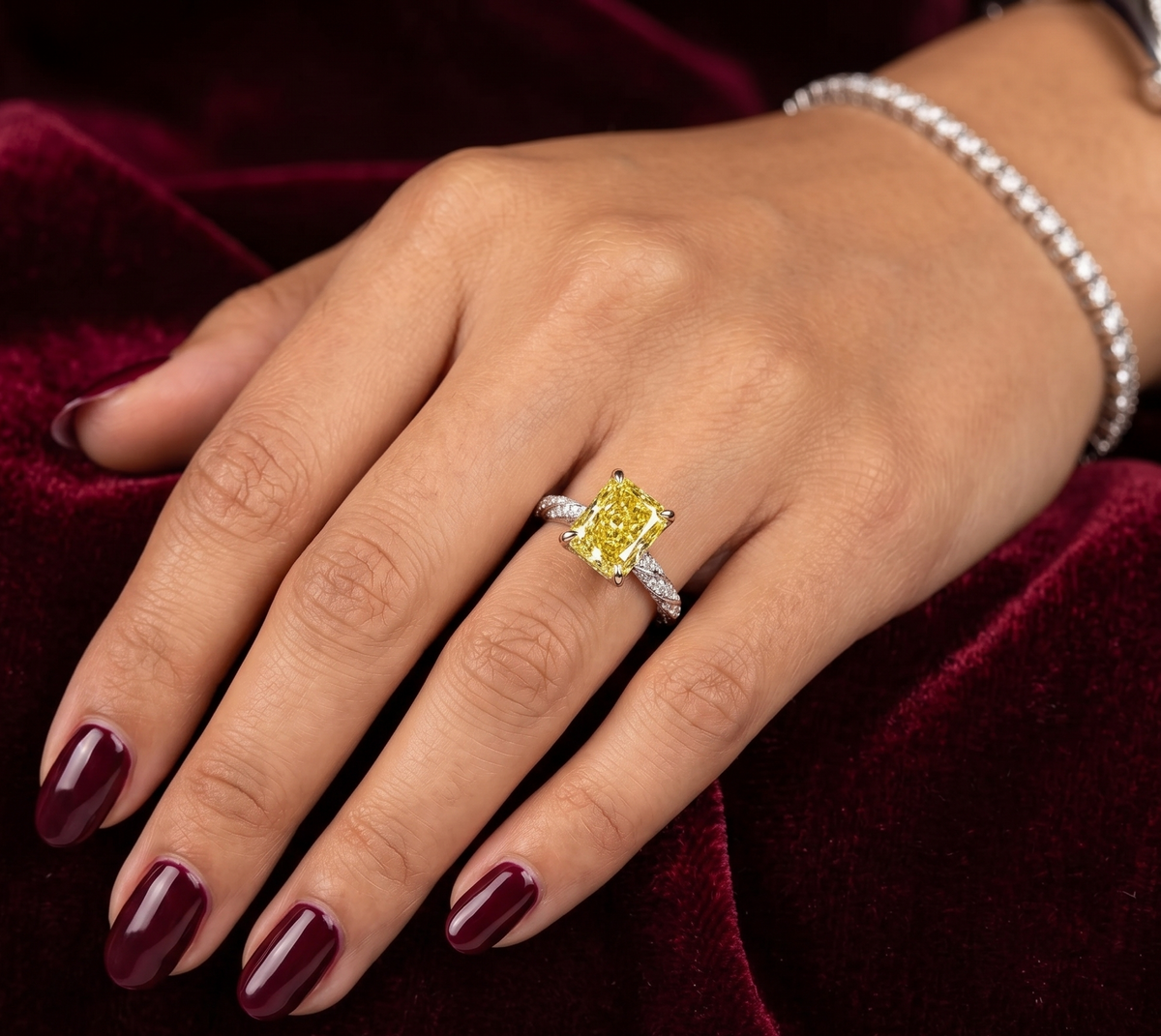 Fancy yellow radiant cut engagement ring on a model