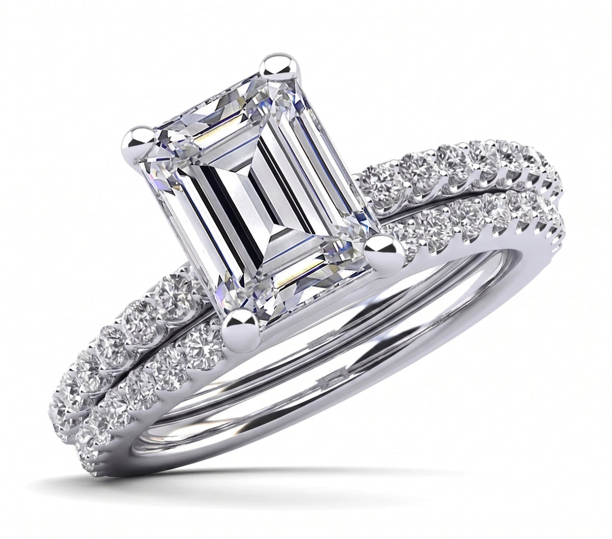 Emerald_cut_engagement_ring_set_with_a_matching_band_white_gold