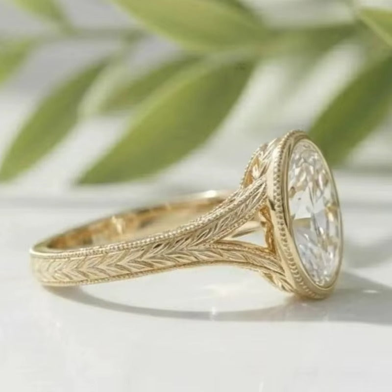 Oval bezel diamond with engraved split shank ring in yellow gold side profile