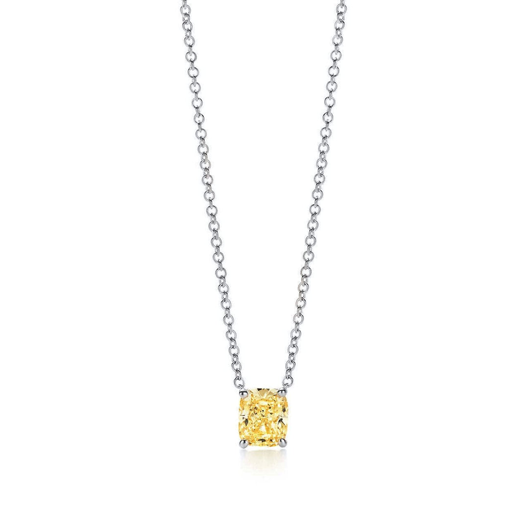 A necklace featuring a cushion cut canary fancy yellow diamond, with a gold pendant and a matching gold chain.