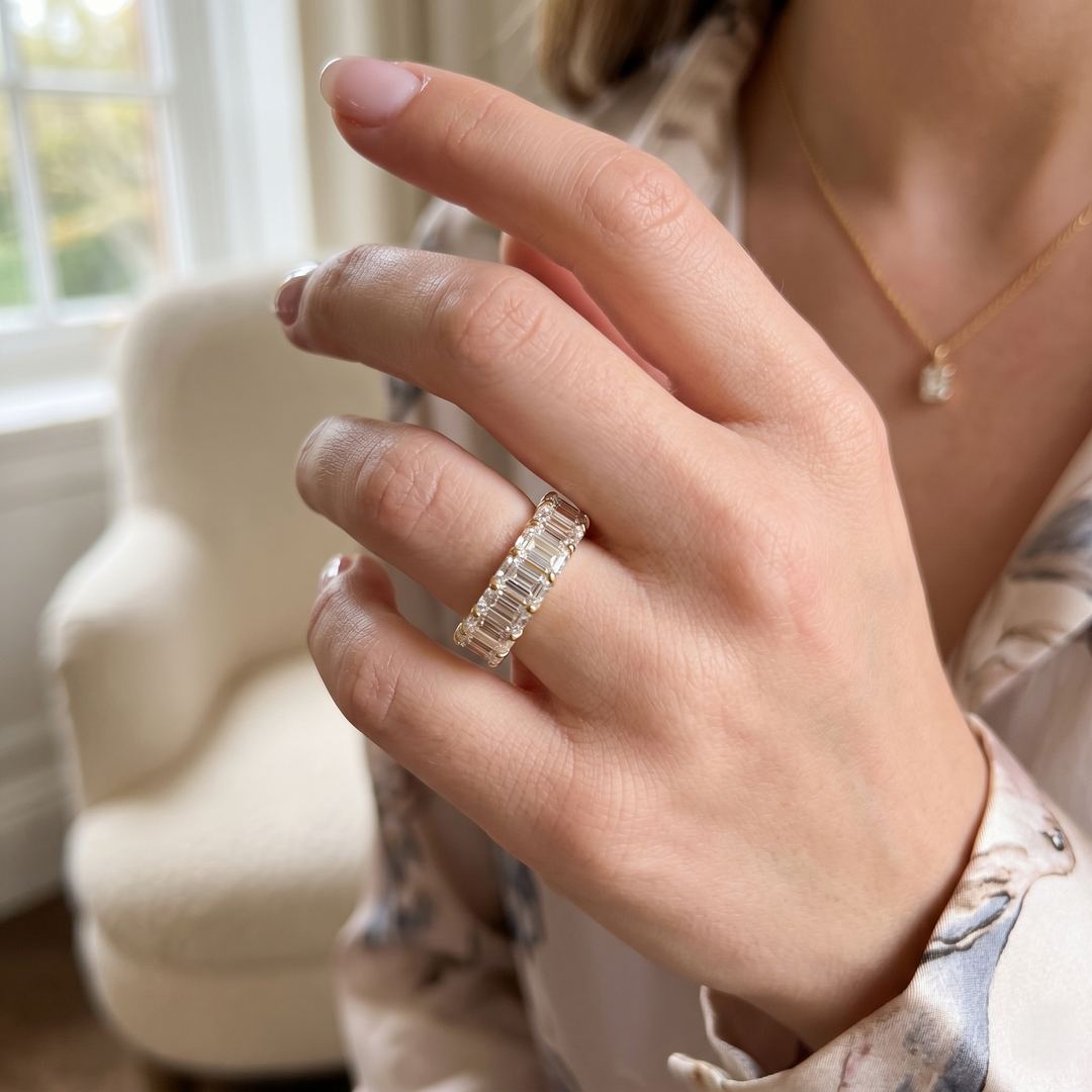 model wearing low profile eternity band emerald cut