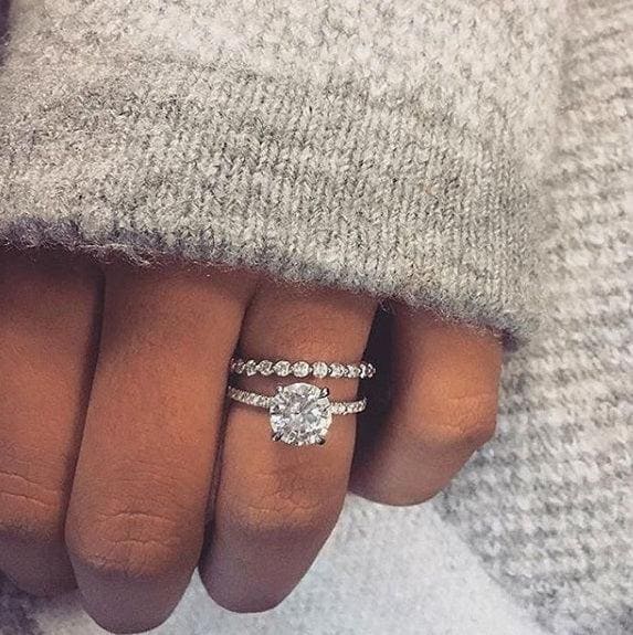Hidden halo engagement ring set on hand