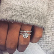 hidden halo engagement ring set on Hand
