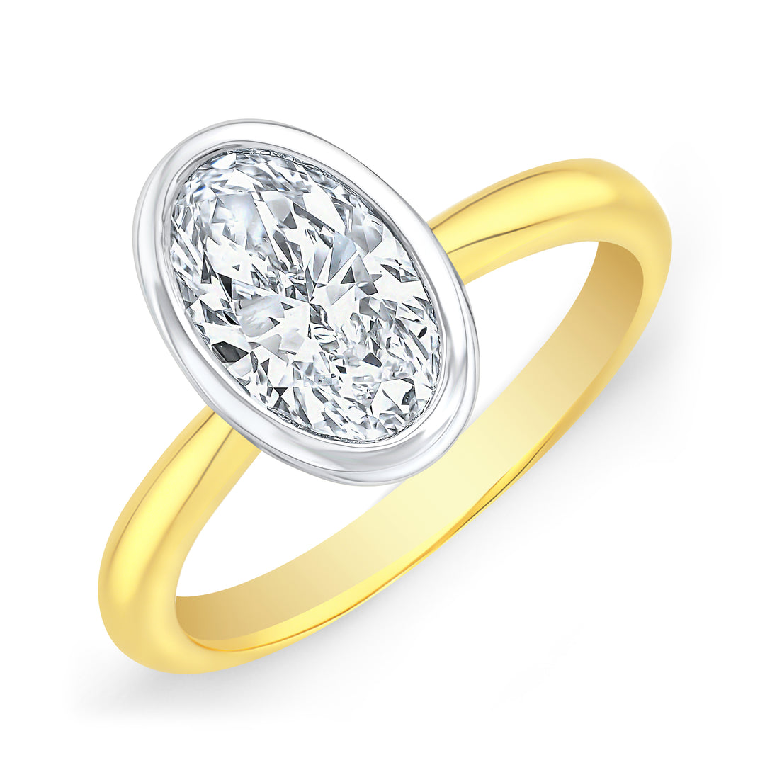 Oval Cut Bezel Set Diamond solitaire ring in white gold bezel with yellow gold band