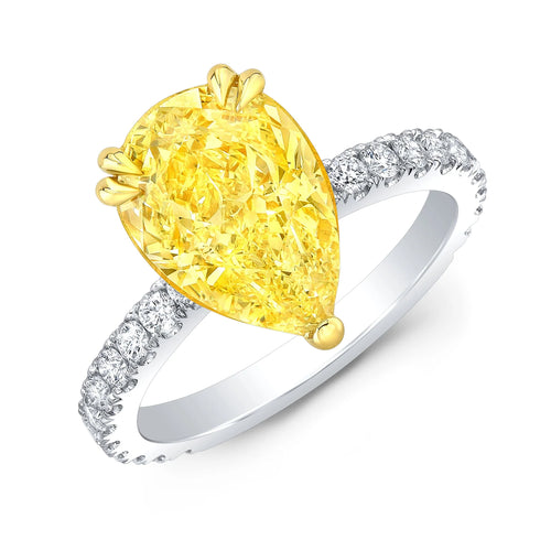 Pear cut yellow center diamond ring in  white gold band with yellow gold prongs