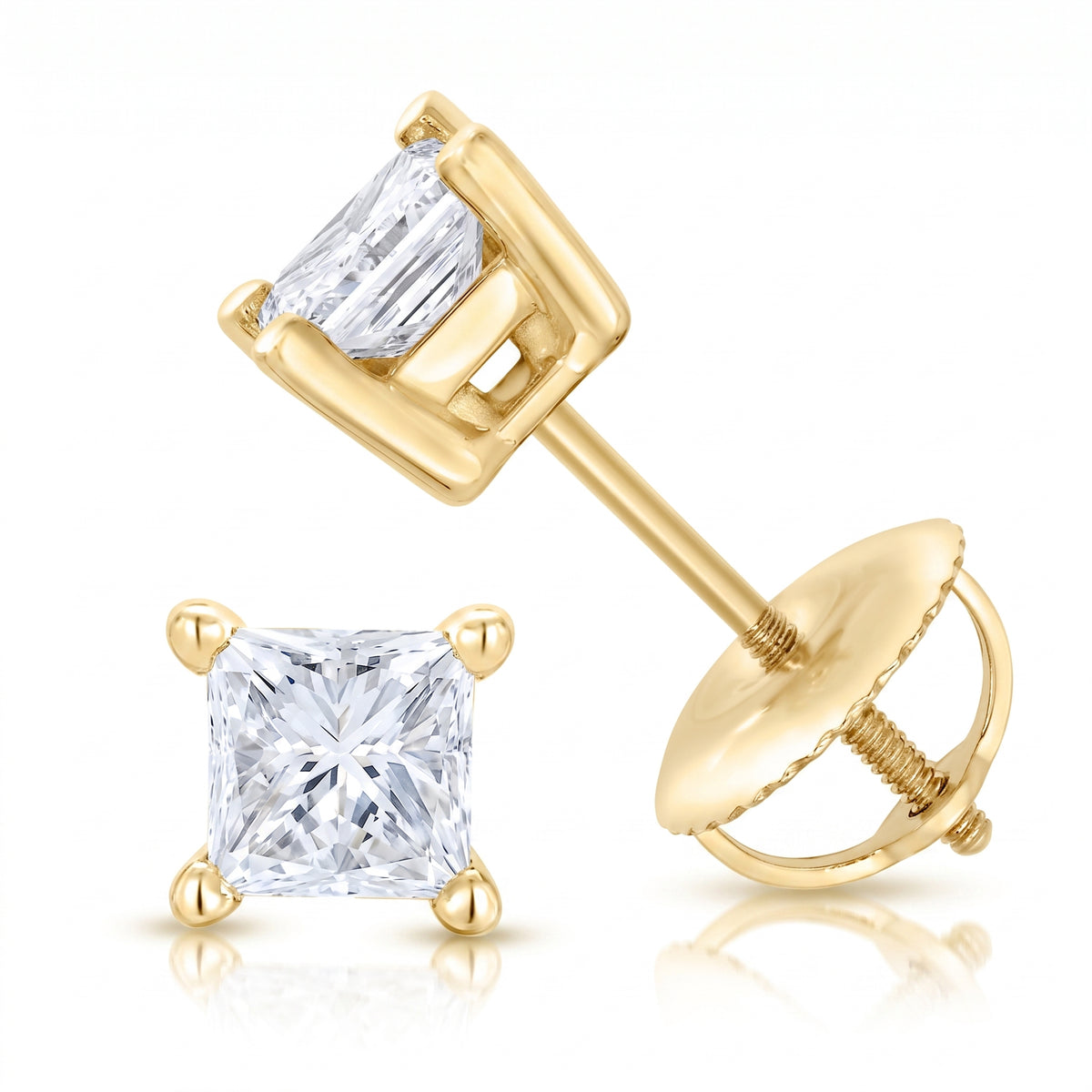 A pair of yellow gold stud earrings with princess cut clear gemstones, showing one front facing earring and one angled earring with its post and flat back visible, on a white background with a soft reflection