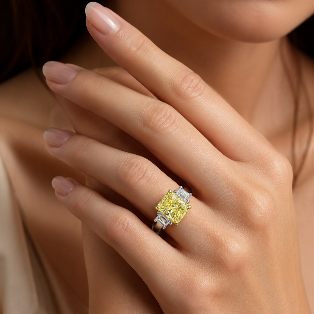 three stone radiant elongated with Trapezoids on a model's finger