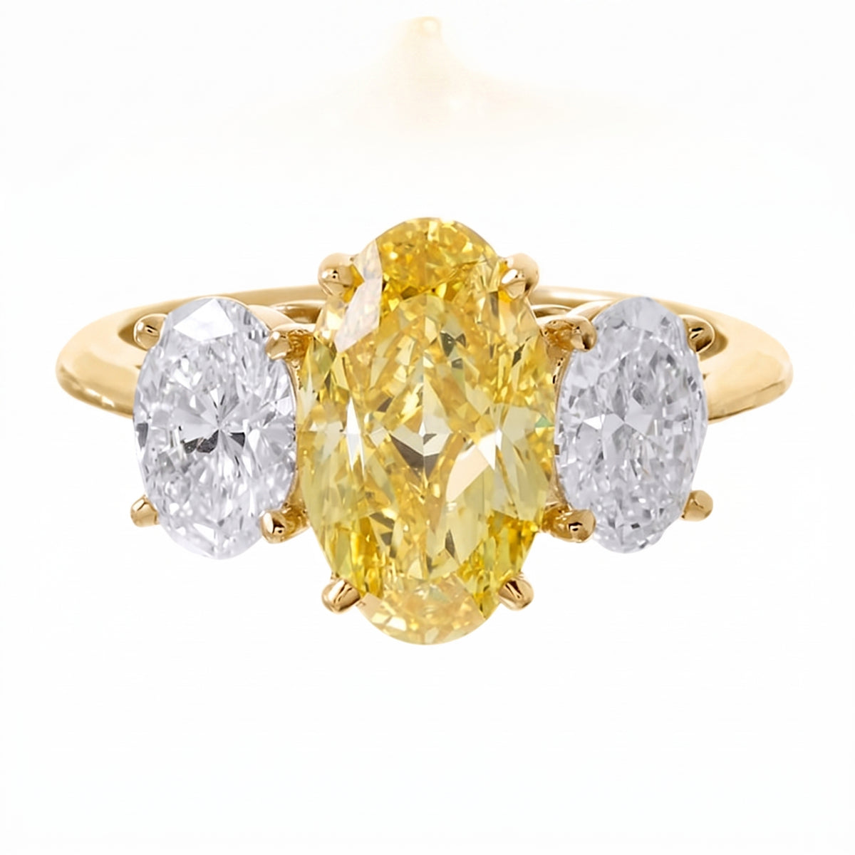 Three_stone_yellow_oval_and_white_side_ovals_diamond_ring_on_yellow_gold_setting