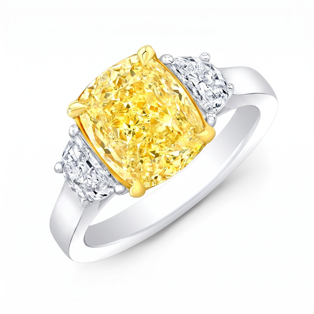 yellow cushion and white half moons on a two tone Three stone ring