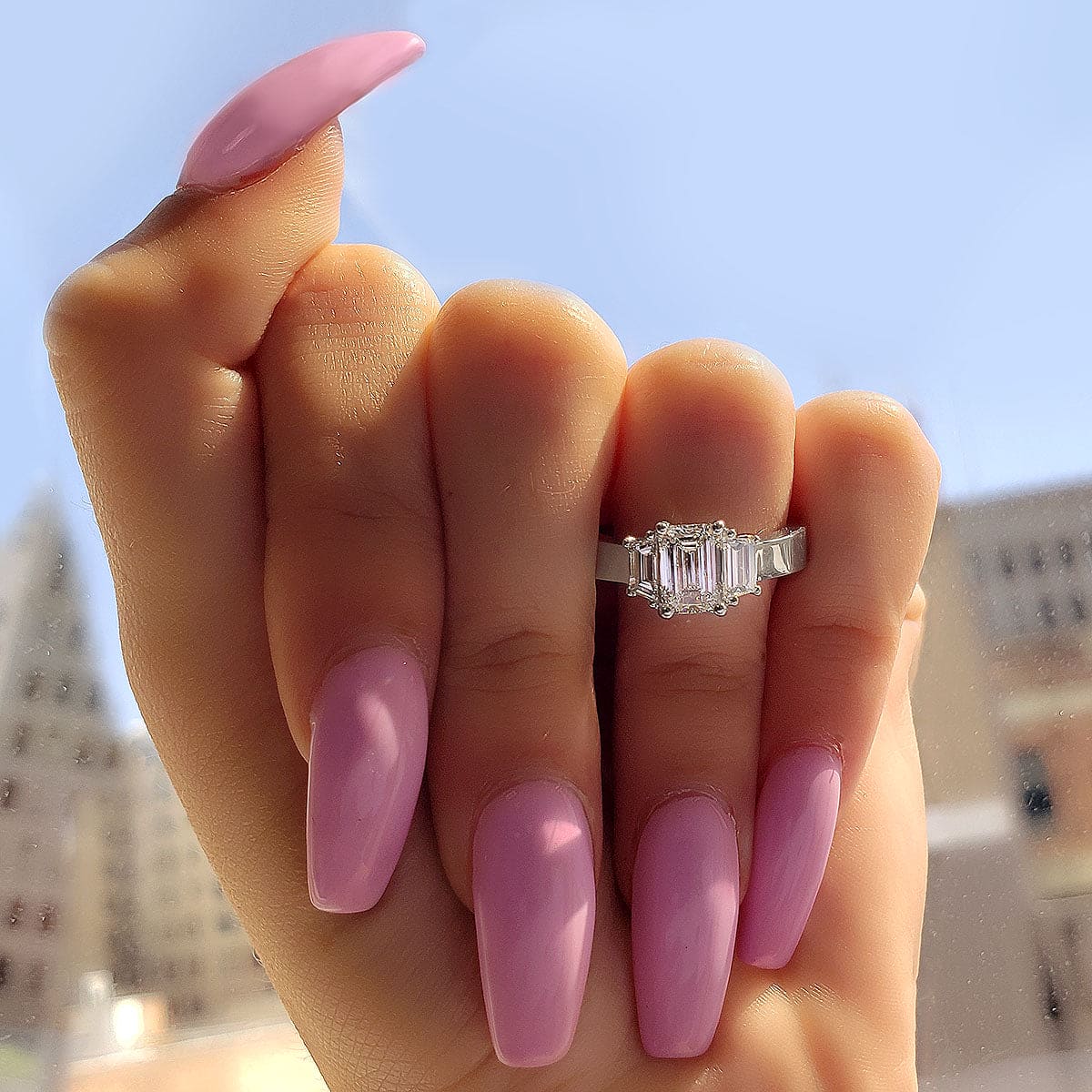 3 stone emerald cut diamond ring w trapezoids on hand