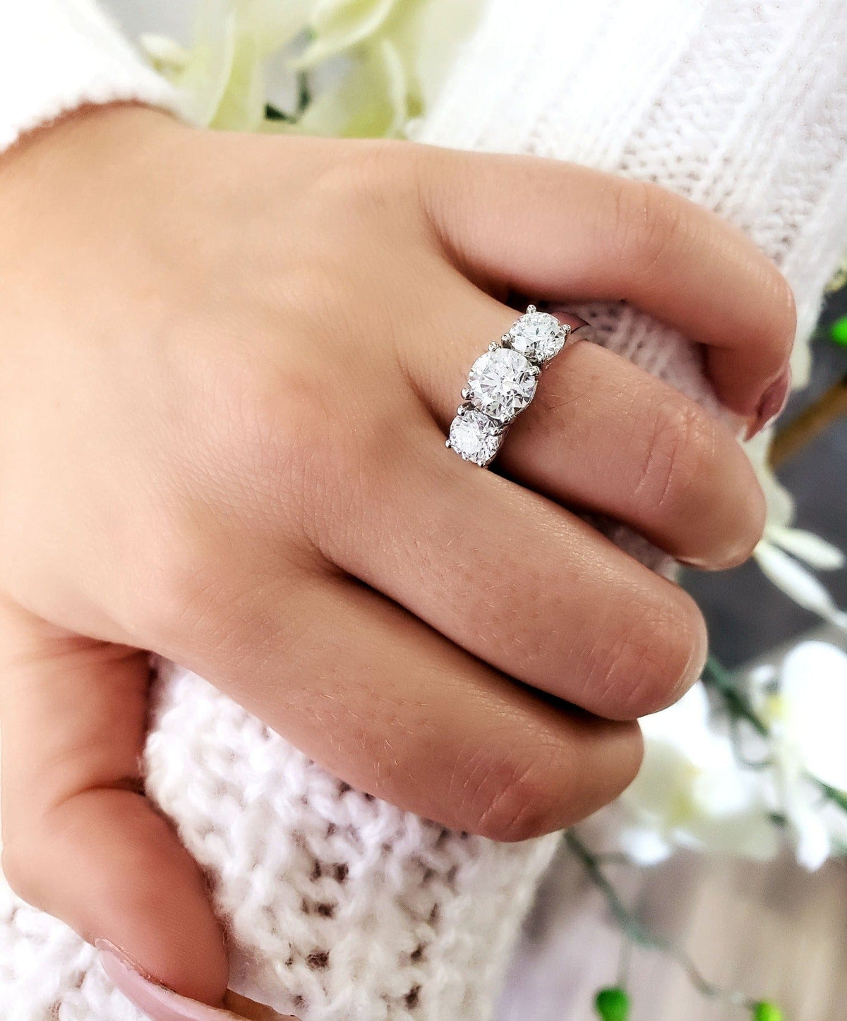 3 stone engagement ring on hand