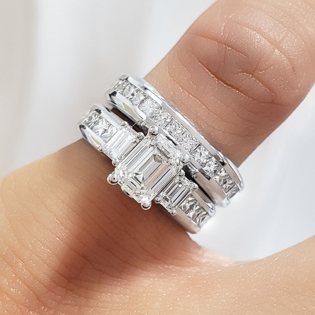 Emerald cut engagement ring set on hand