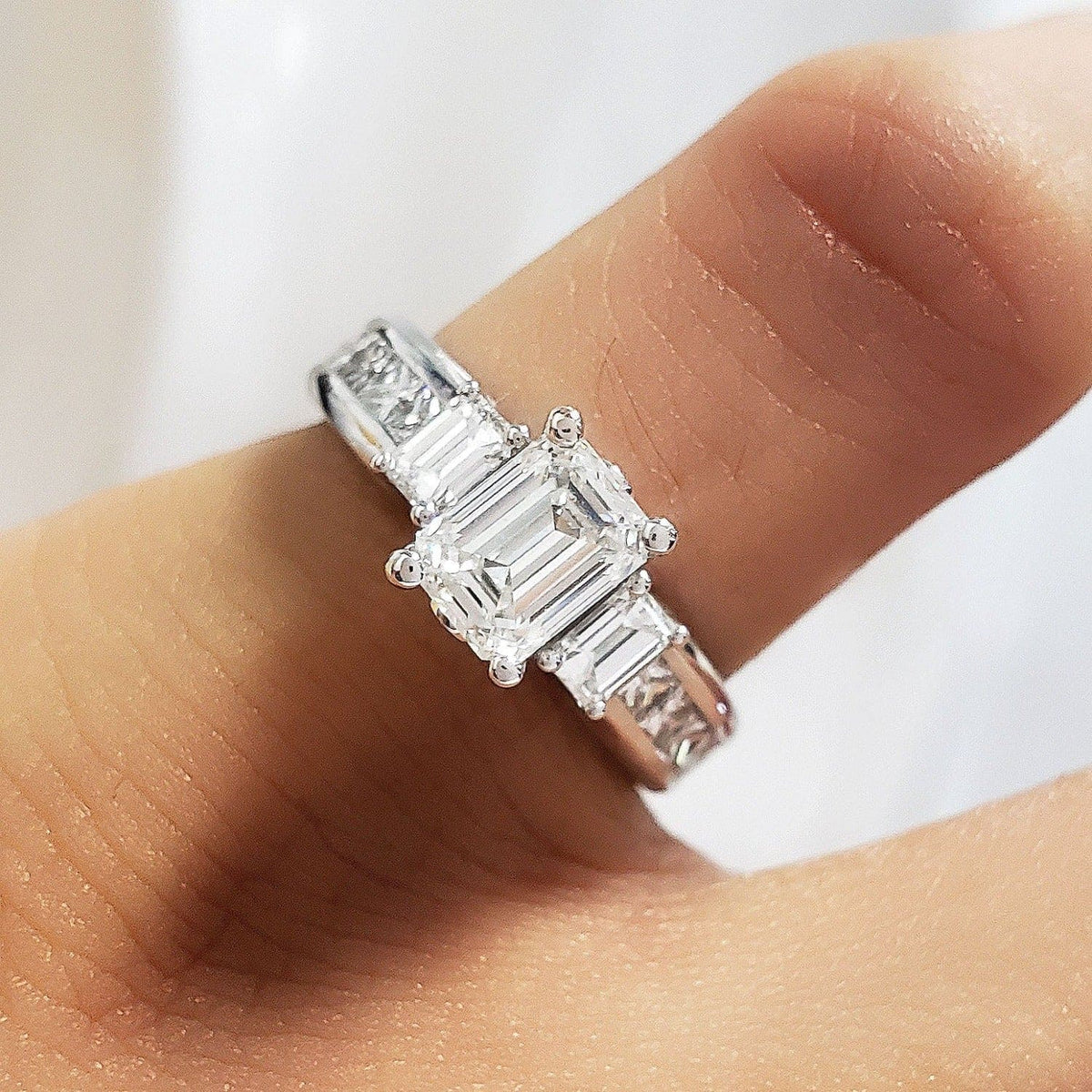 Emerald cut engagement ring on hand