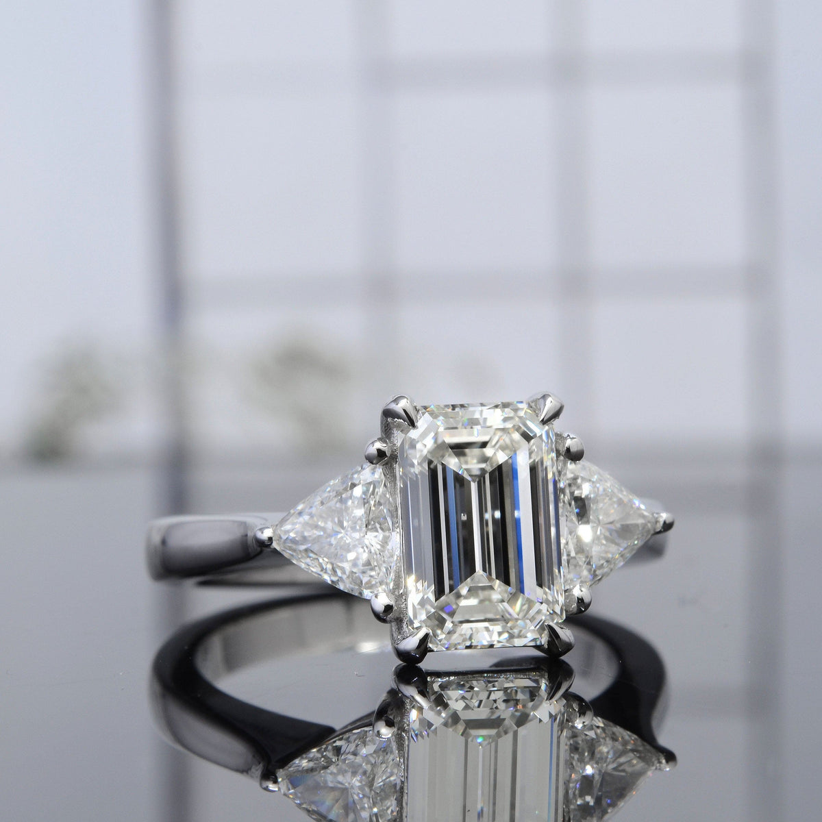 3stone diamond ring with emerald cut and trillions
