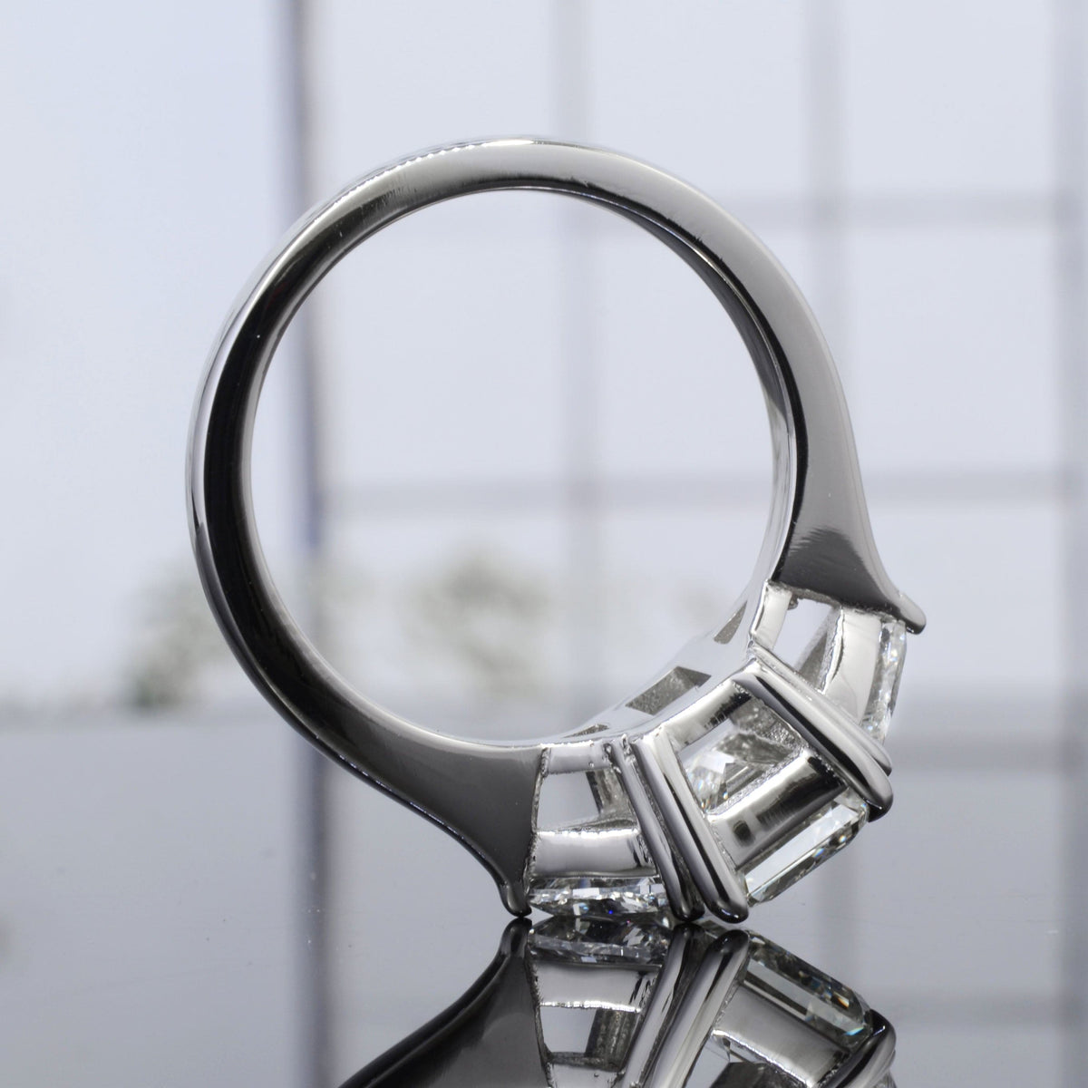 Emerald cut & trillions 3stone diamond ring side profile