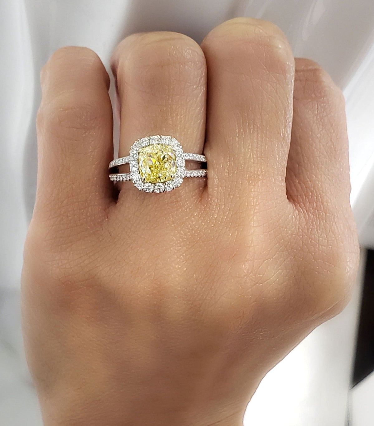 Canary fancy yellow cushion cut halo diamond ring on hand