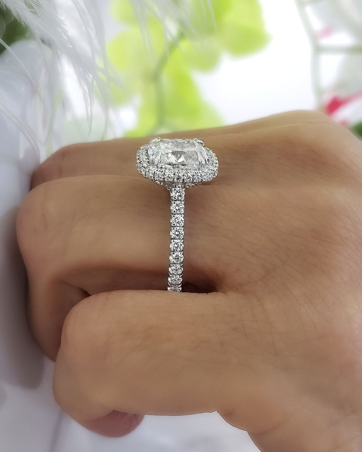 Halo & hidden halo cushion engagement ring on hand