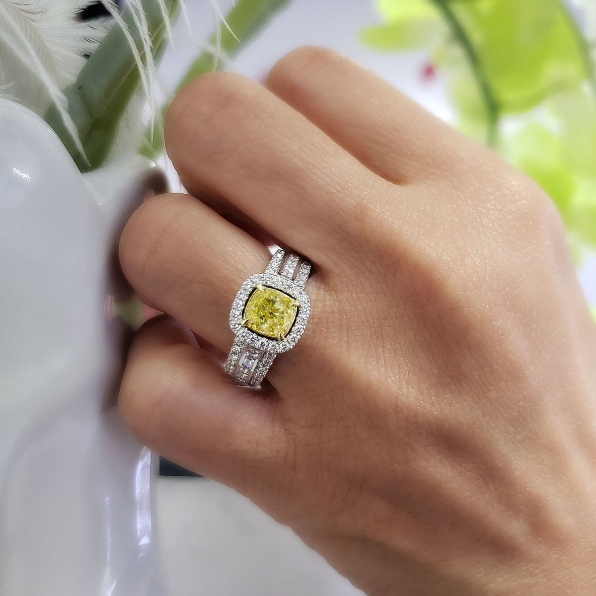  yellow canary cushion cut halo engagement ring on hand