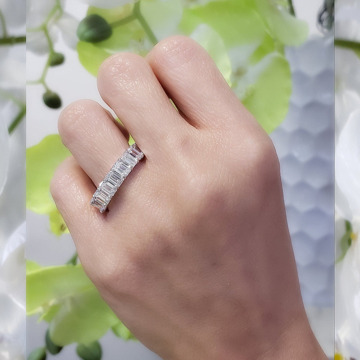 Emerald cut eternity band on finger