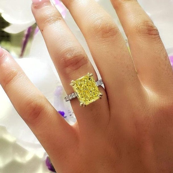 Elongated radiant cut canary fancy light yellow diamond ring 