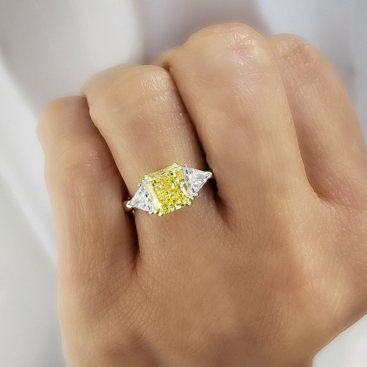 Yellow 3stone radiant cut diamond ring on hand