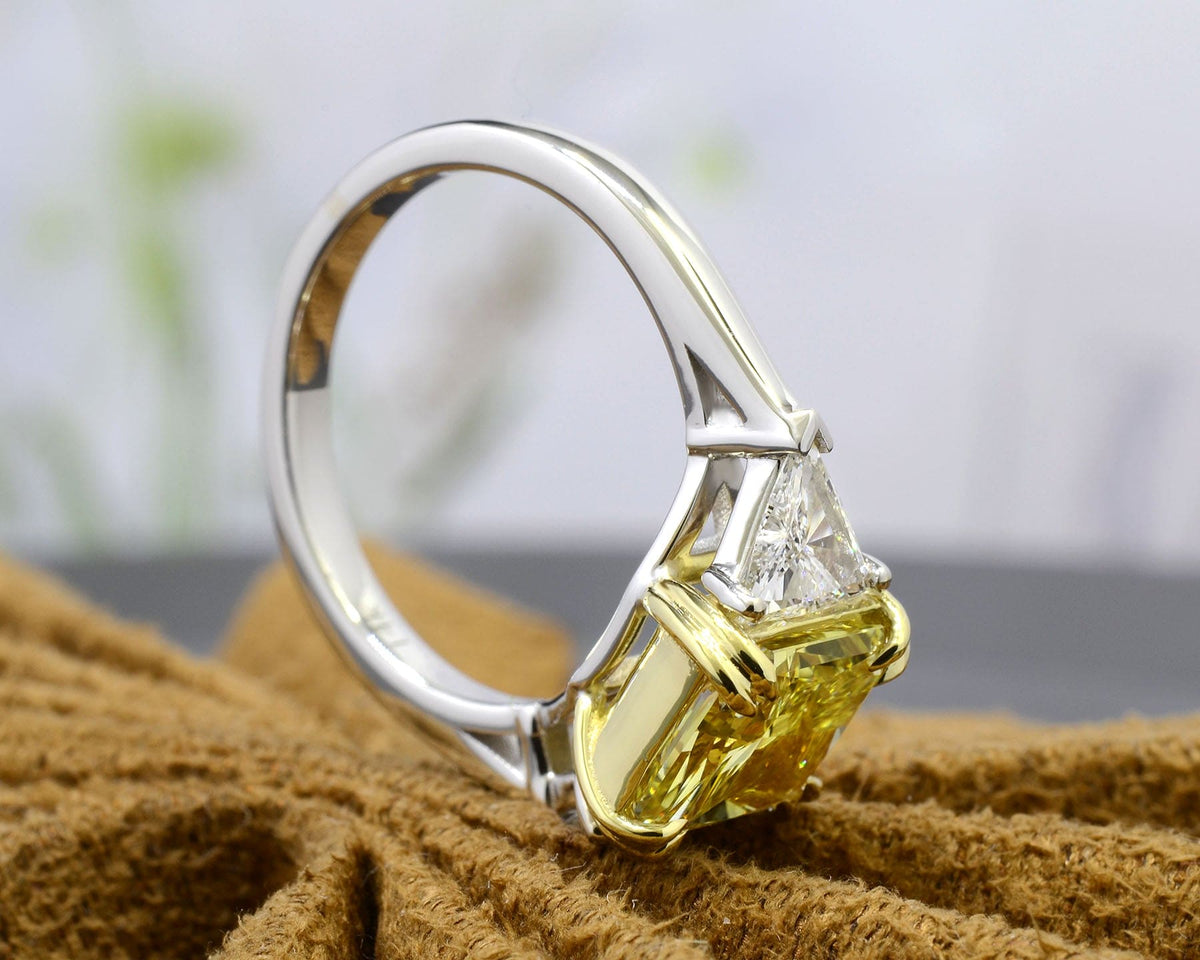 Fancy light yellow radiant cut 3 stone diamond ring profile view