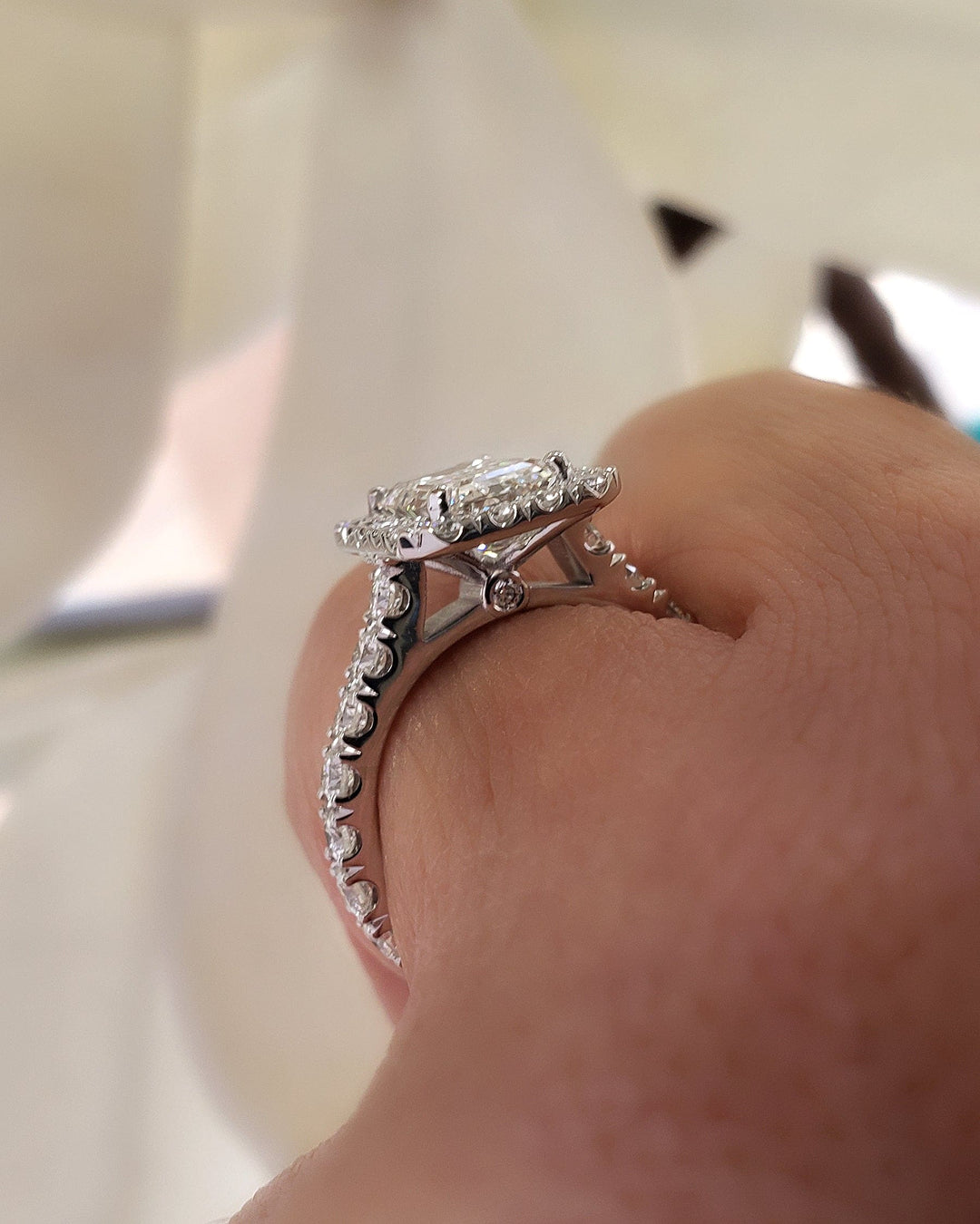  Emerald Cut Halo Engagement Ring on hand side view