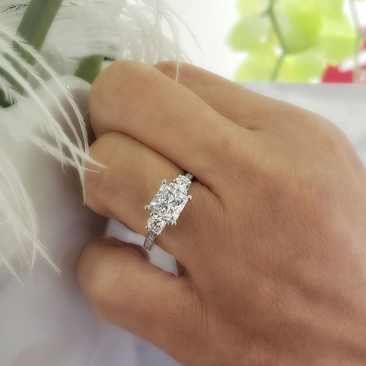 3 stone princess cut diamond ring with rounds on hand