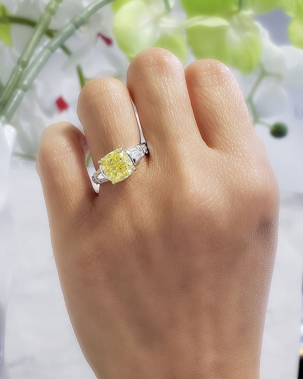 Yellow cushion cut diamond ring w baguettes on hand