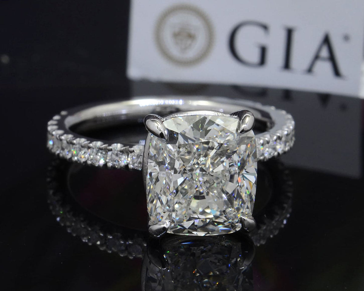 Cushion cut diamond ring with accent