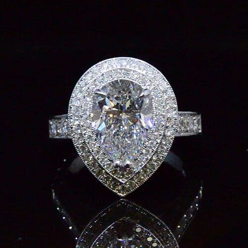 Pear cut double halo hand carved diamond ring