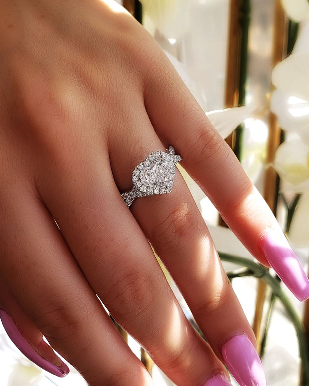 heart shaped halo ring on hand