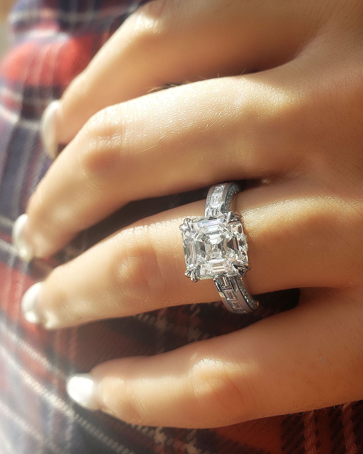 Asscher cut diamond ring with baguettes on hand