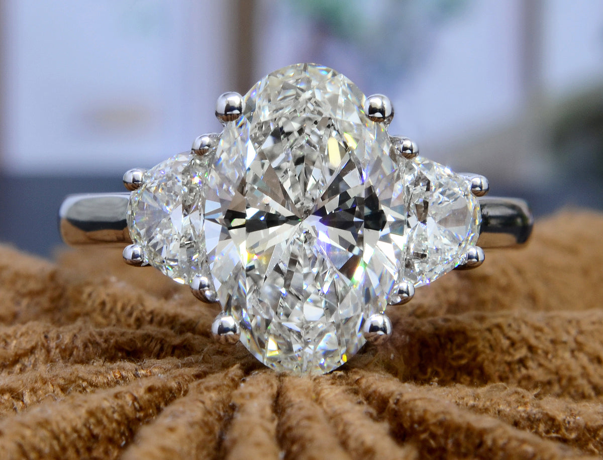 3 stone oval & half moons engagement ring