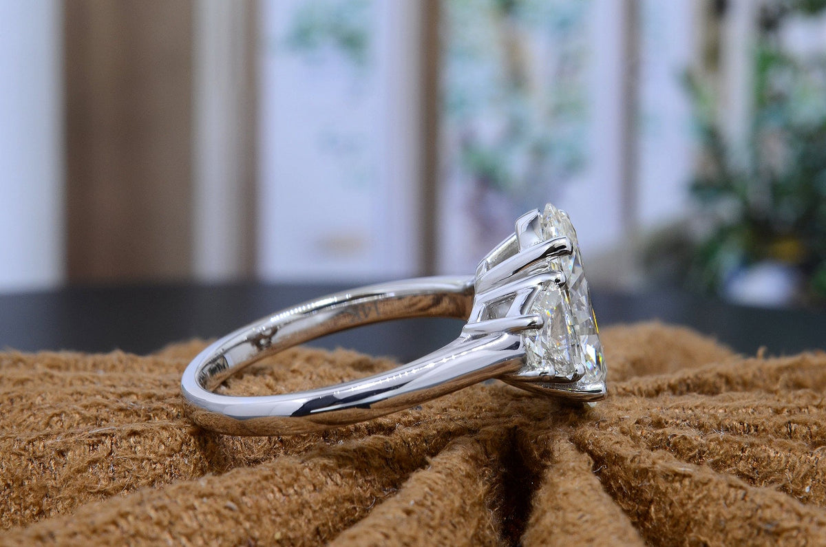 Oval 3 stone engagement ring with half moons side view