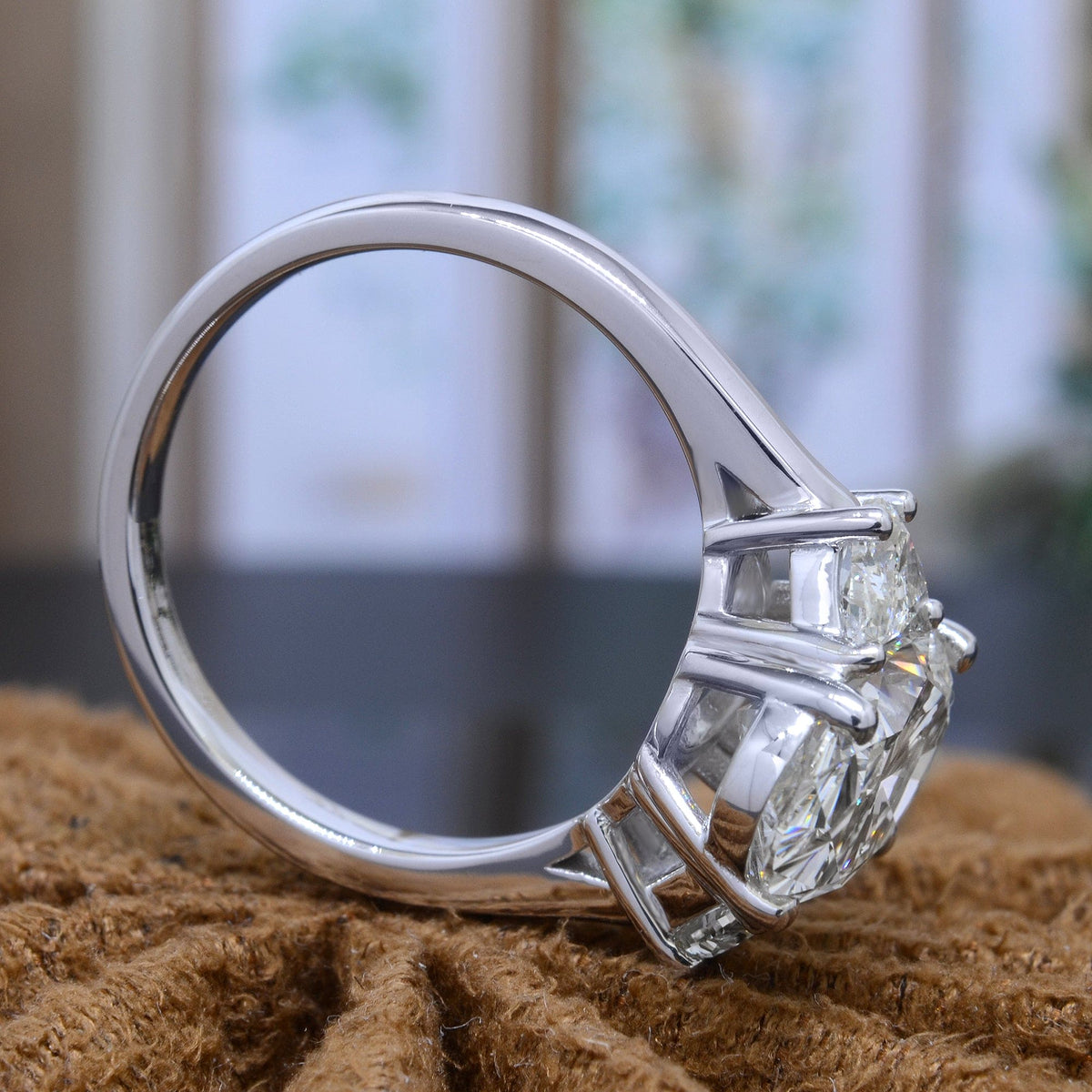 3 stone oval & half moons engagement ring side profile