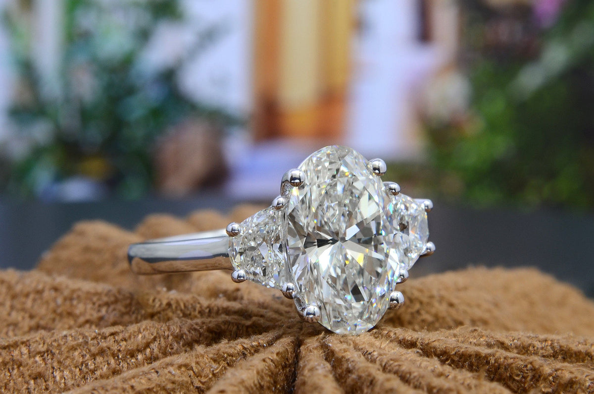 Oval 3 stone engagement ring with half moons