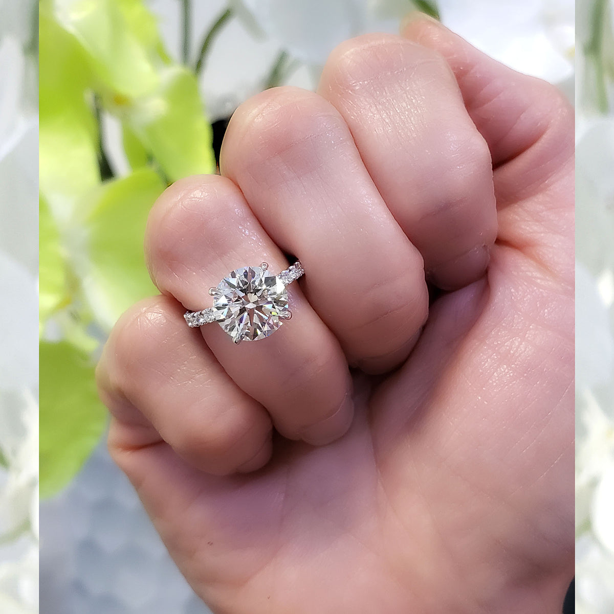 Hidden halo engagement ring round cut on hand