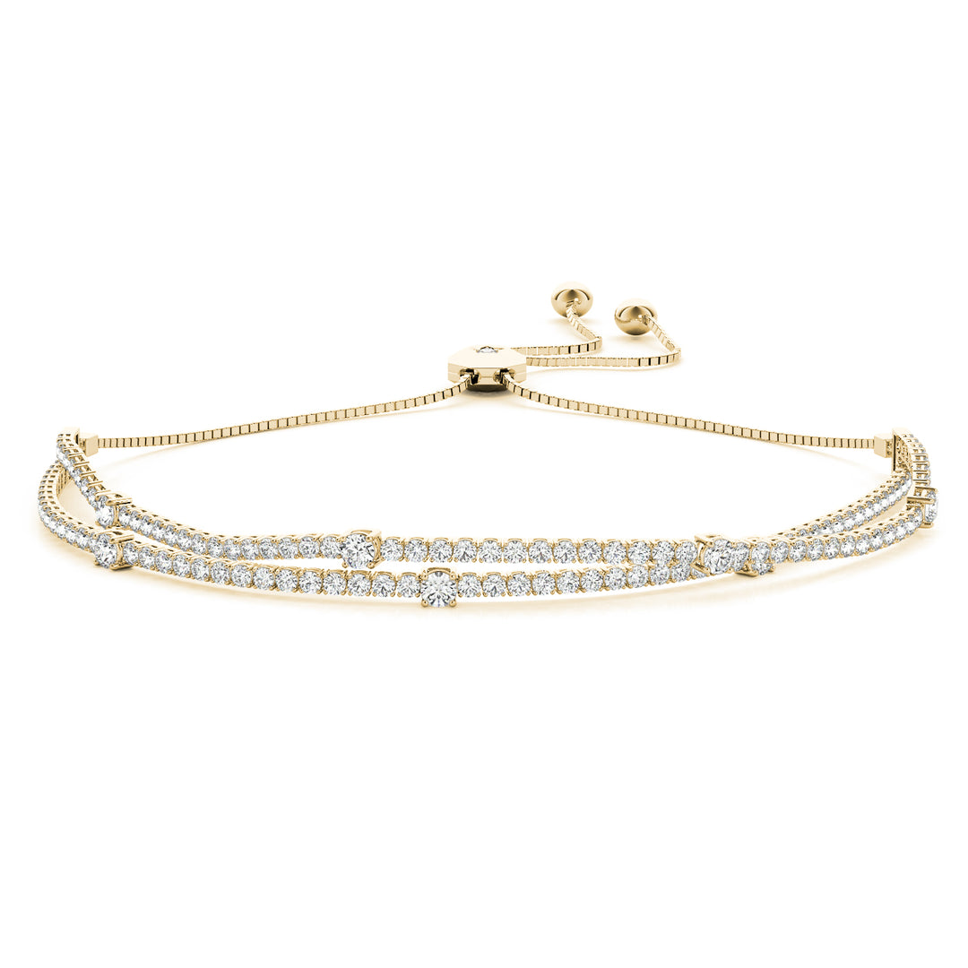 Gold bracelet with diamond accents on a white background