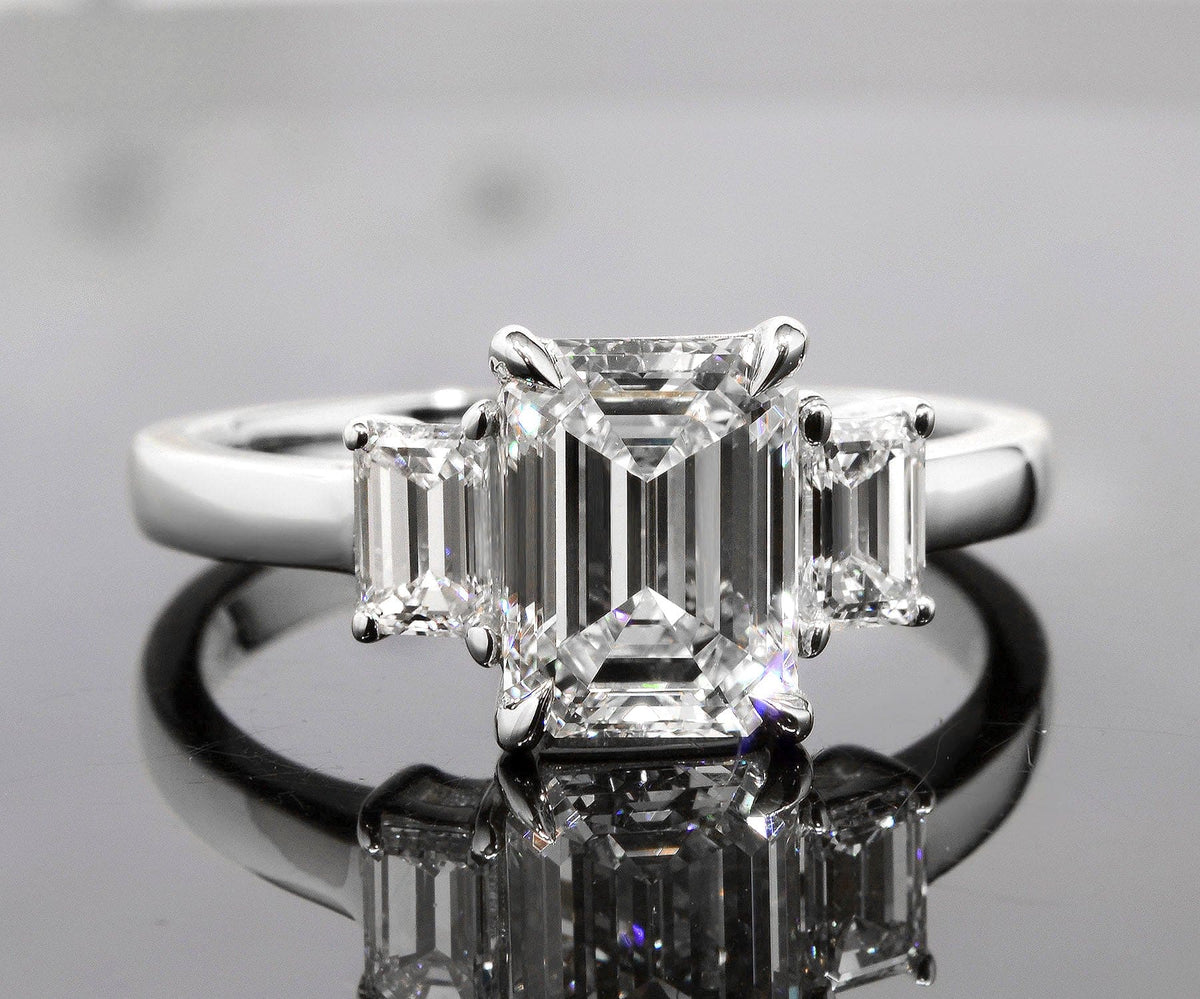 3 stone emerald cut engagement ring front view
