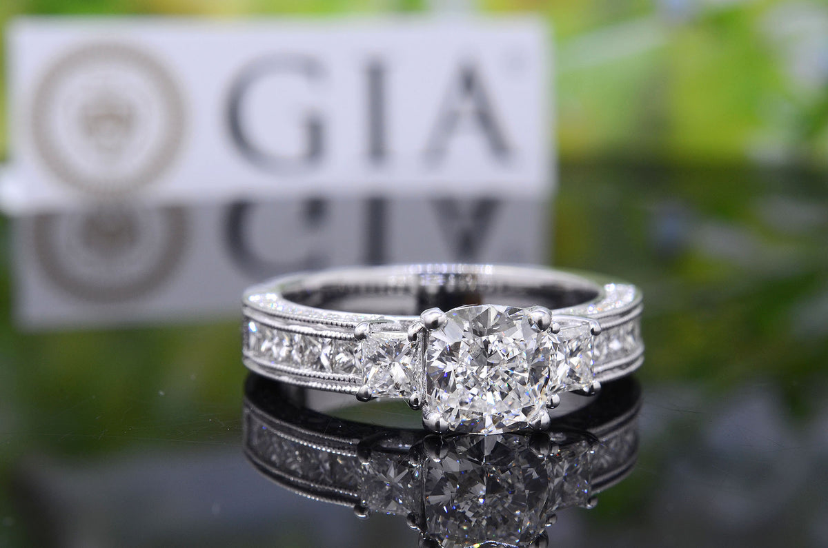 Cushion cut 3 stone engagement ring with accents