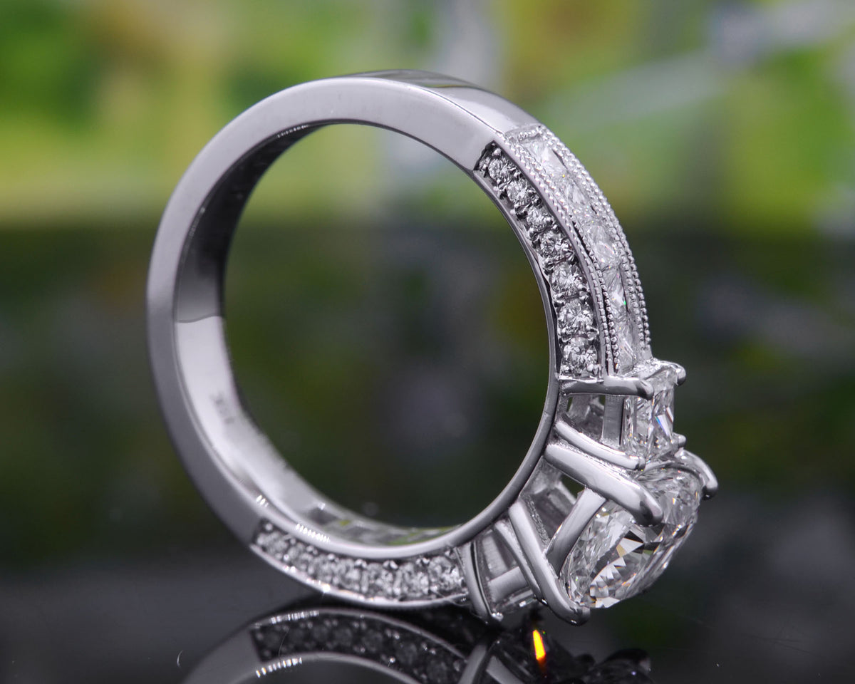 Cushion cut 3 stone engagement ring with accents side profile