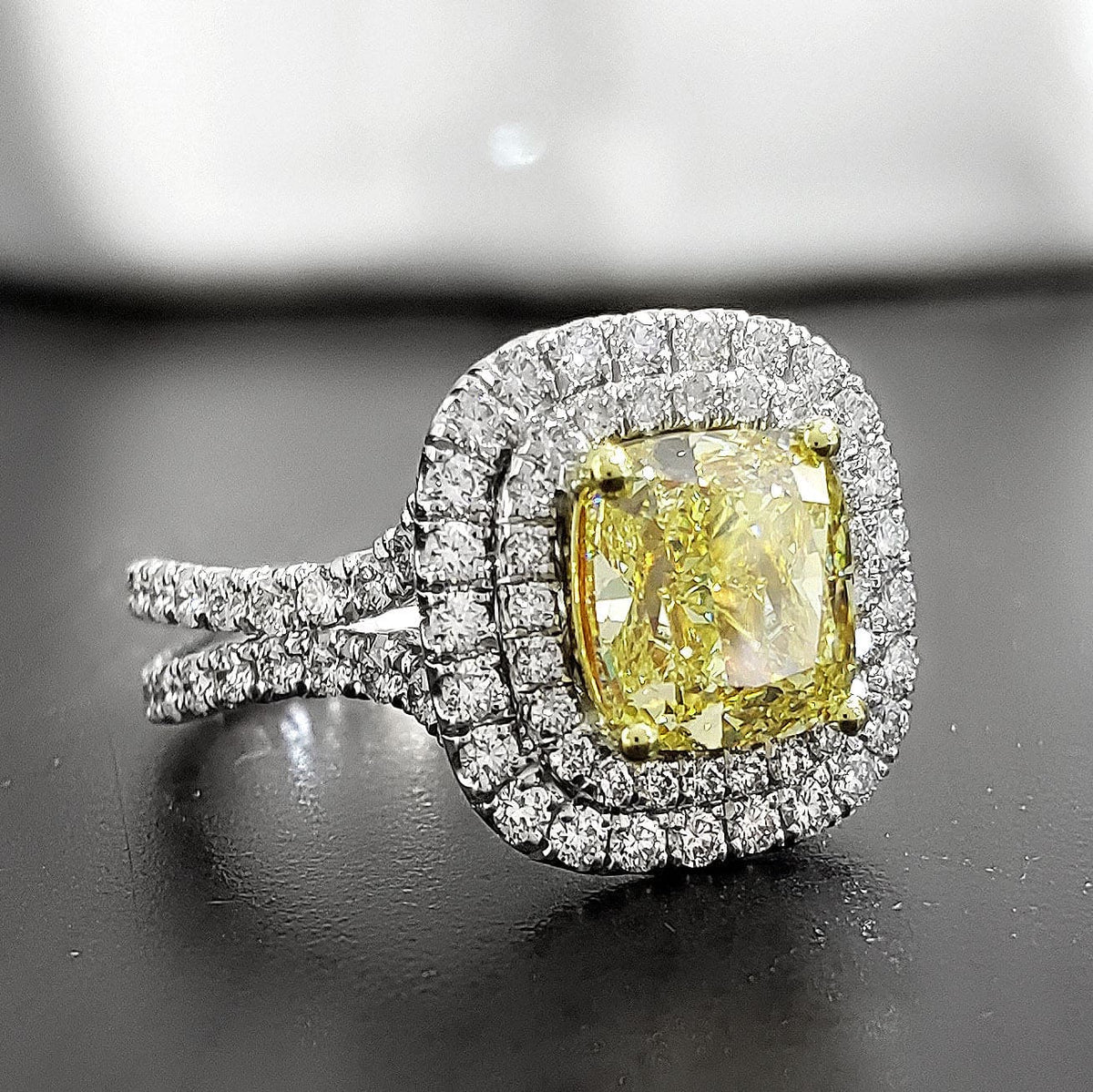 Dual halo canary fancy yellow cushion cut diamond ring