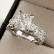 Cushion Cut 3 Stone Diamond Ring with Accents on Ring Box